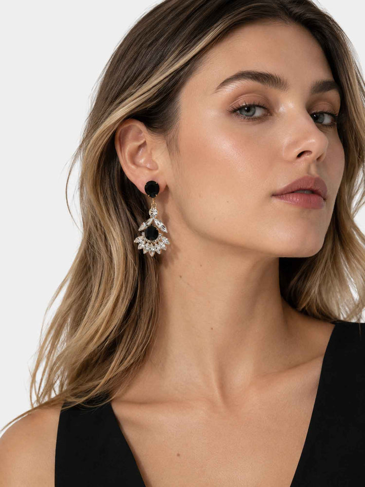 Model wearing Maura black crystal fan drop earrings with black outfit
