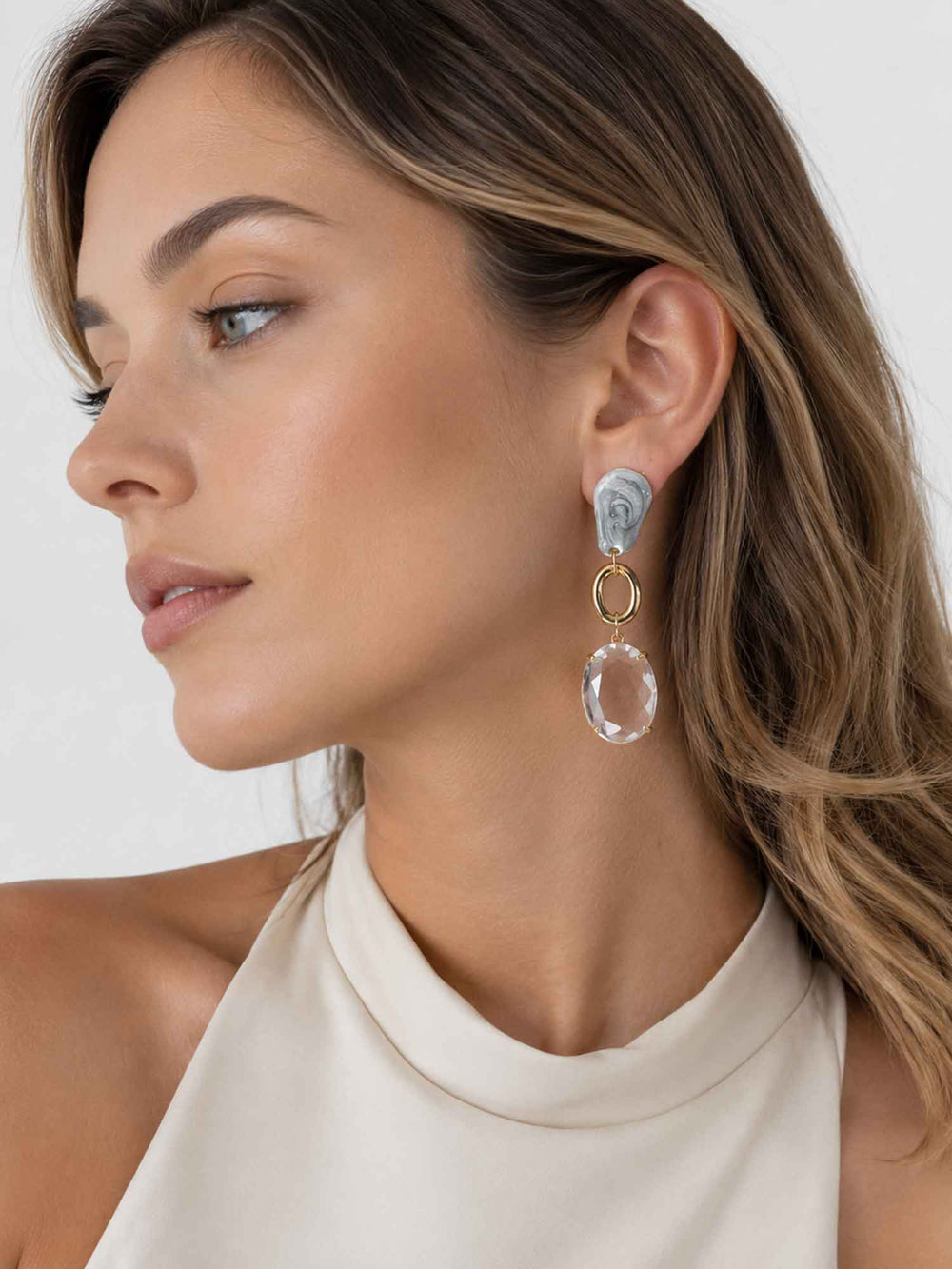 Model wearing Meadow grey crystal drop earrings with evening styling