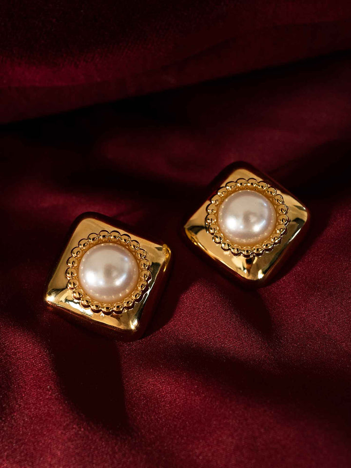 Melina acrylic pearl gold stud earrings styled on red fabric