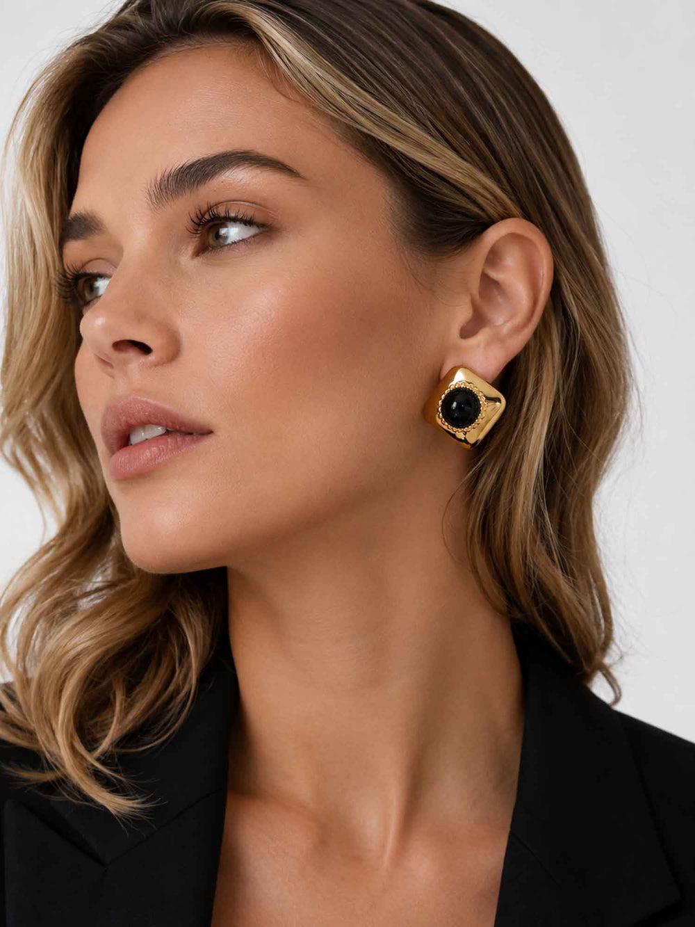 Side view of model wearing Melina Midnight black acrylic gold stud earrings