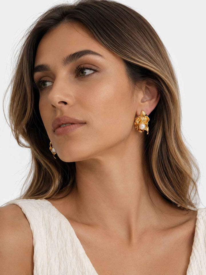 Side view of model wearing Minette sculptural pearl gold stud earrings
