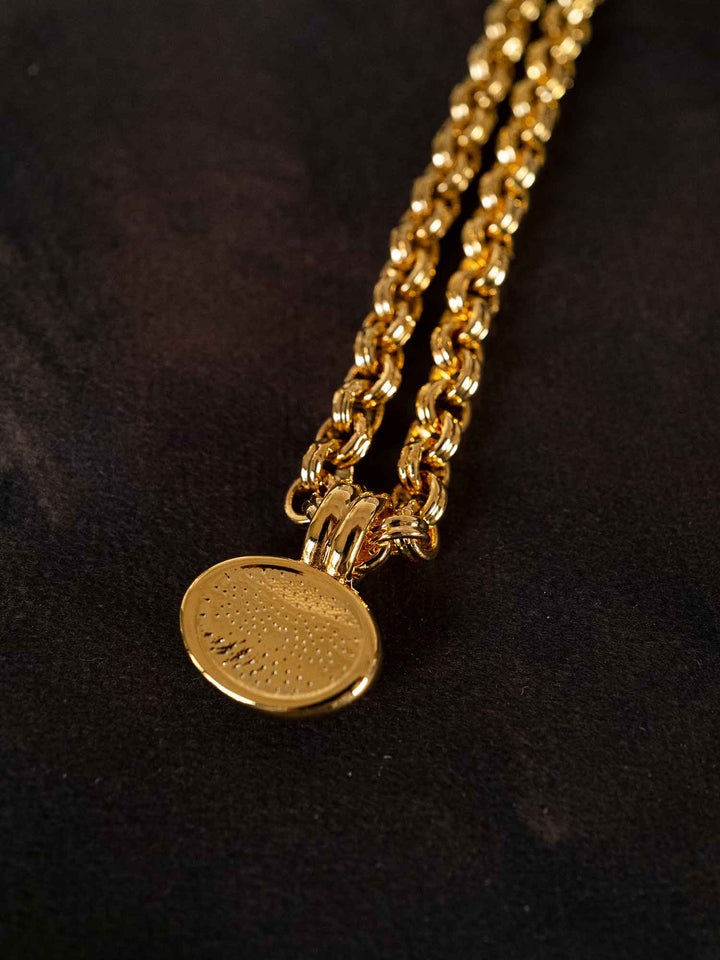 Night of Peace cat eye gold pendant necklace styled on dark fabric