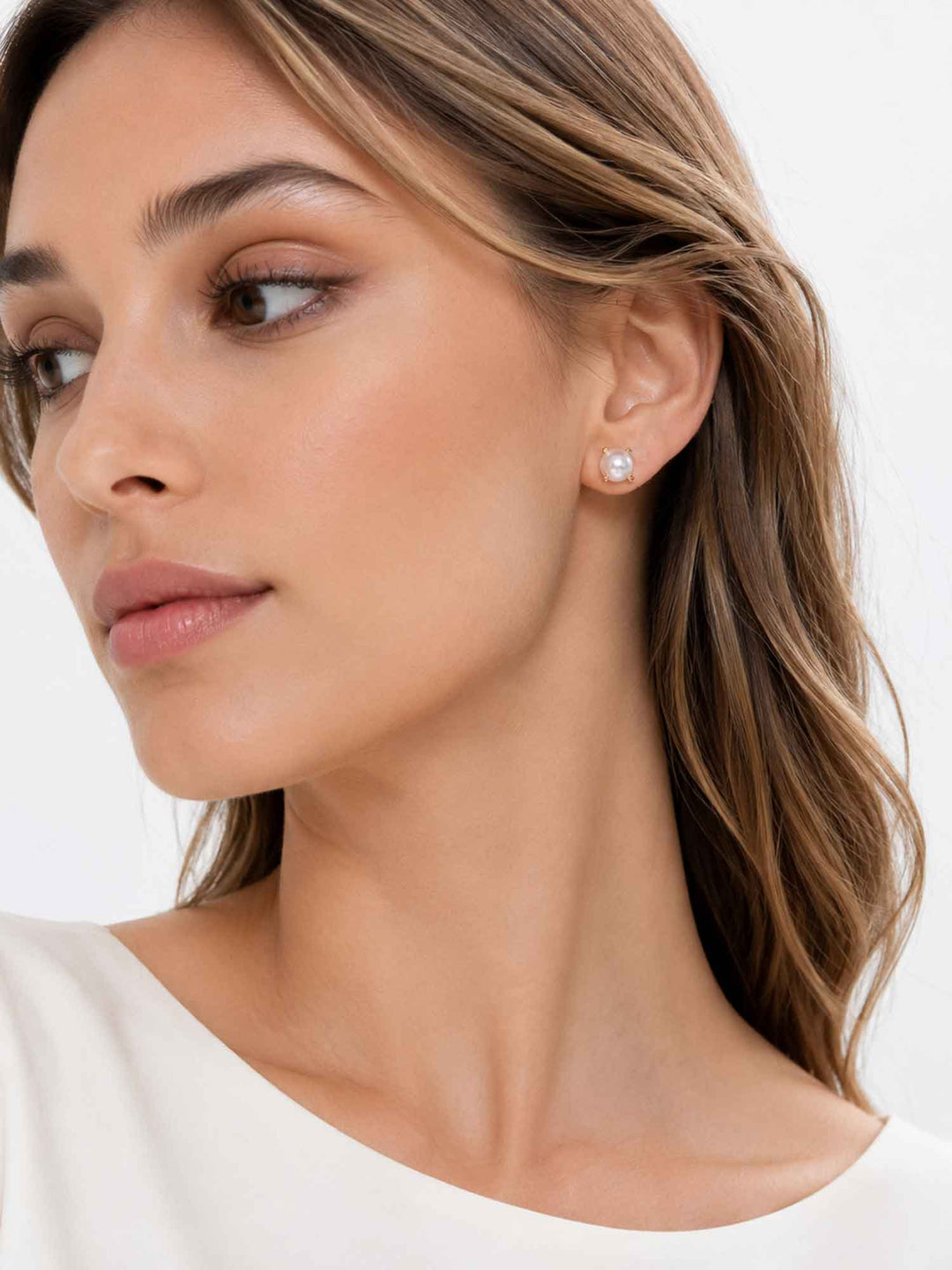 Profile view of model wearing Nuala glass pearl stud earrings