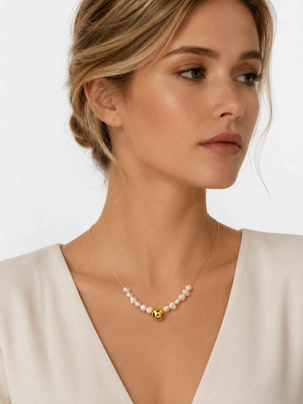 Model wearing Petra freshwater pearl gold bead necklace with elegant styling