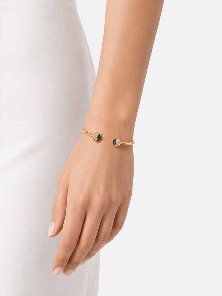 Philippa blue stone gold cuff bracelet worn on wrist