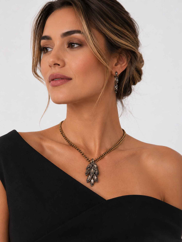 Model wearing Selene smoky crystal leaf pendant necklace with black outfit