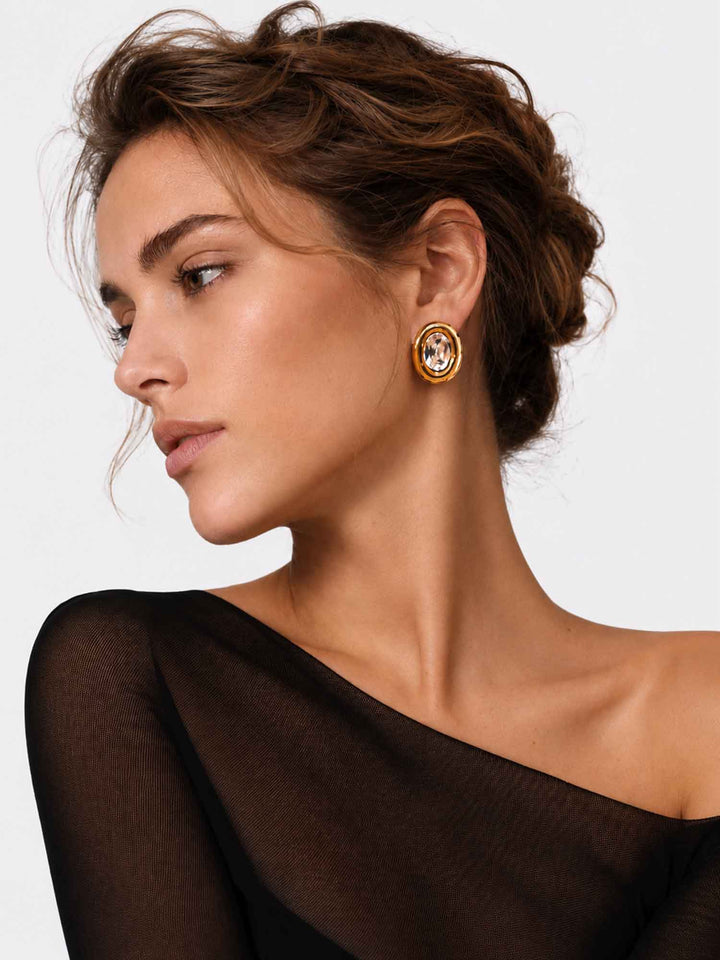 Model wearing Sparkle oval crystal gold stud earrings with evening styling