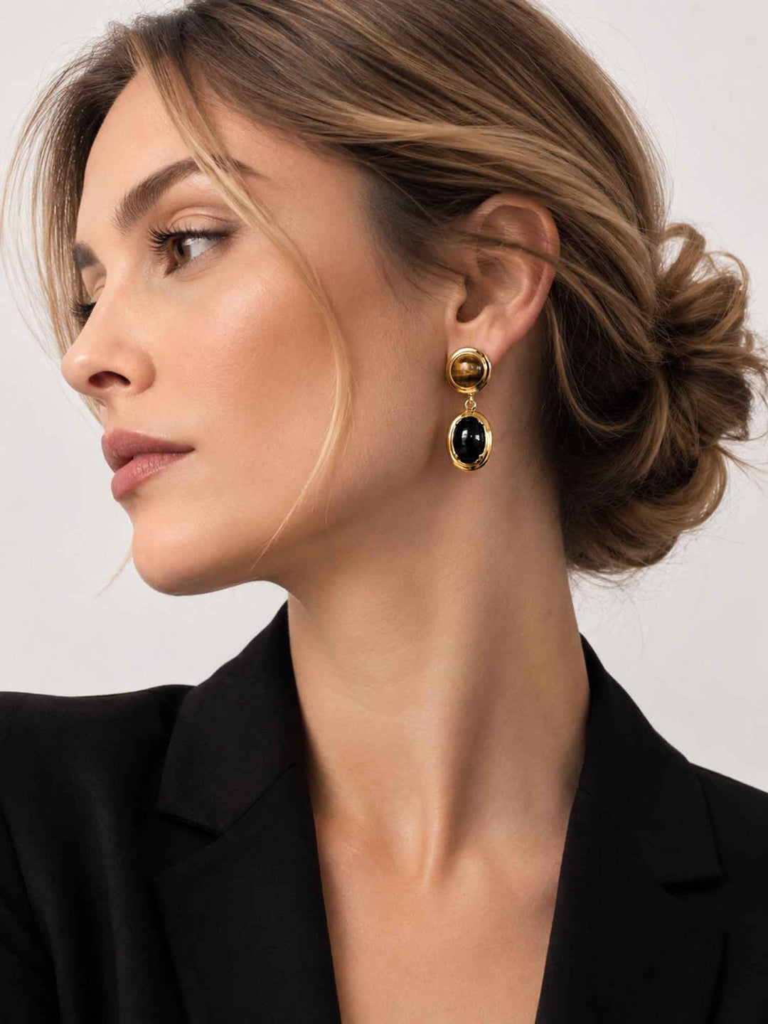 Side view of model wearing Spectral tiger eye and obsidian drop earrings