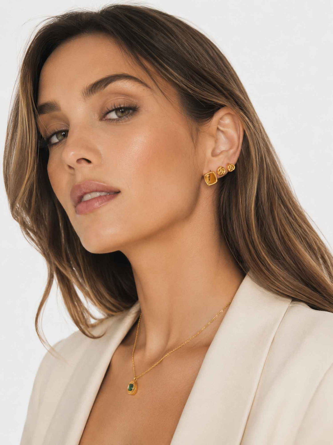 Side view of model wearing square and knot gold cartilage earring set