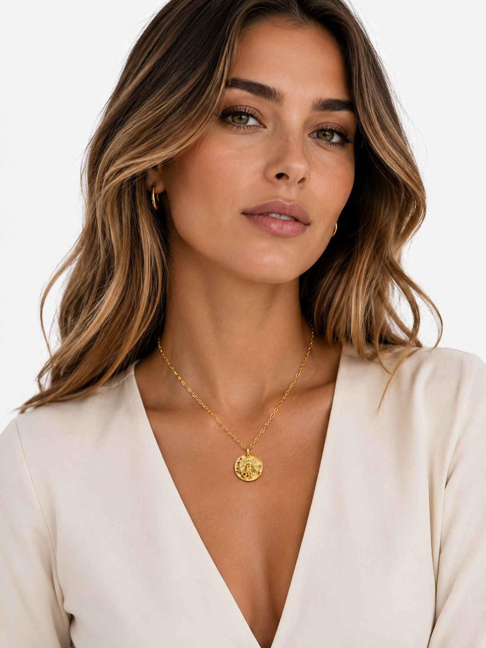 Model wearing Sydney angel medallion gold pendant necklace with elegant styling