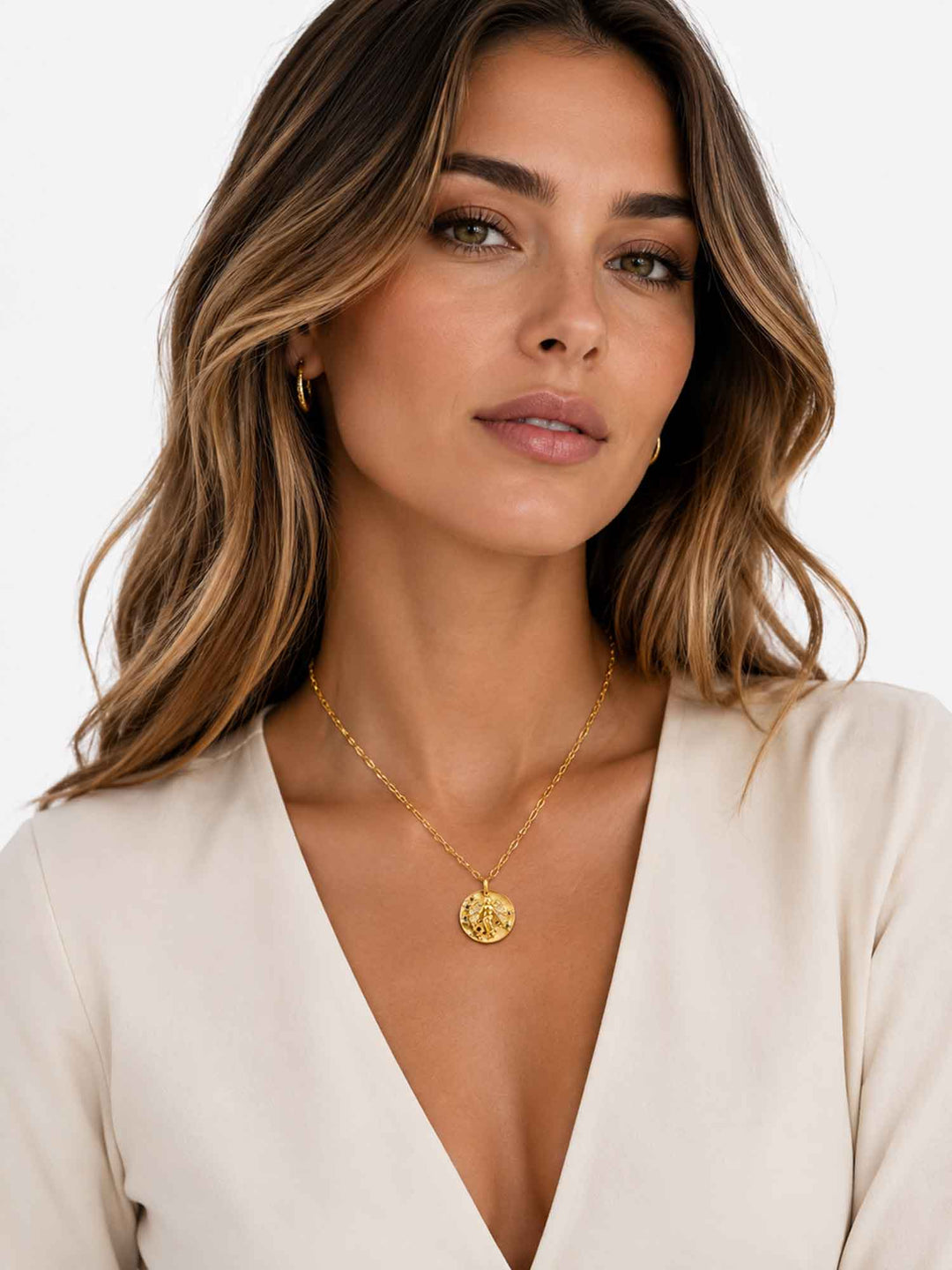 Model wearing Sydney angel medallion gold pendant necklace with elegant styling