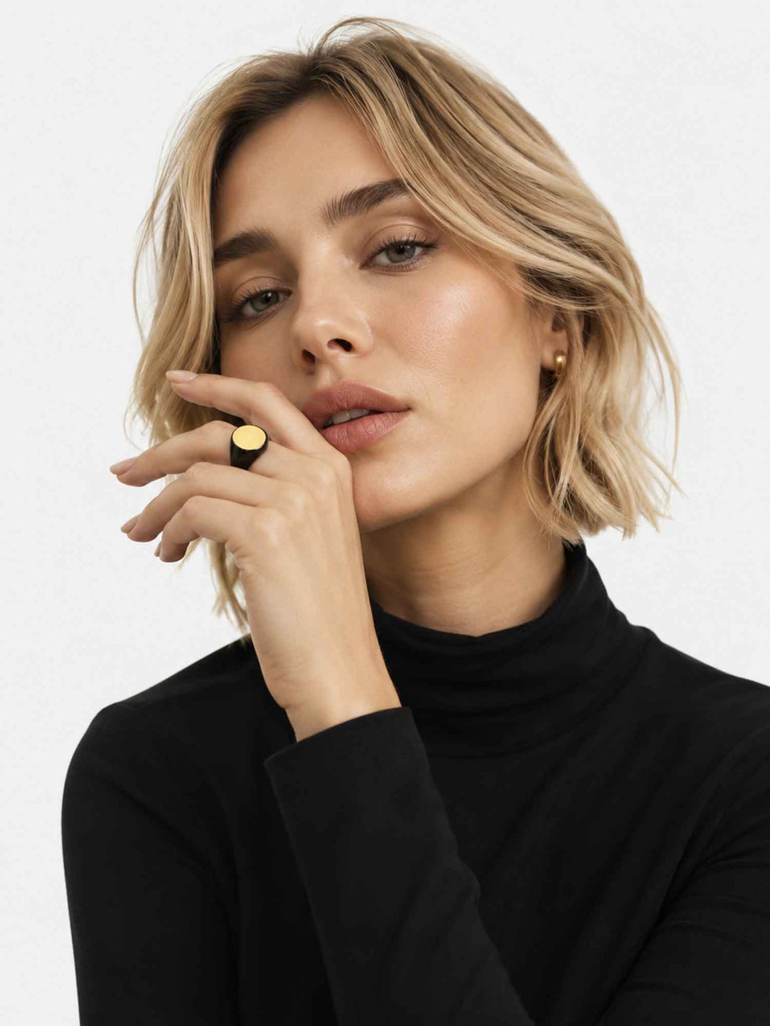 Close-up view of model wearing Timara black enamel gold signet ring