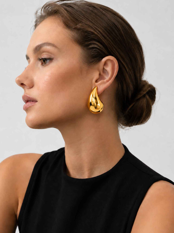 Side view of model wearing Titania large gold teardrop earrings