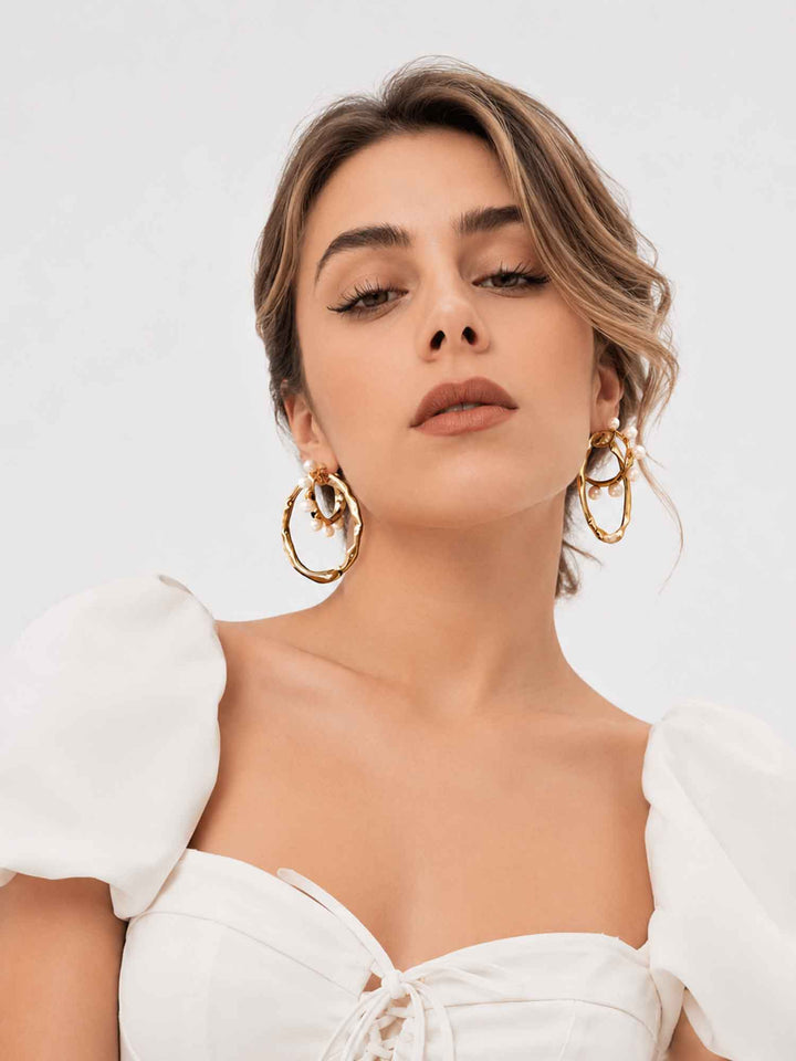 Model wearing two-way detachable cotton pearl gold hoop earrings with bridal styling