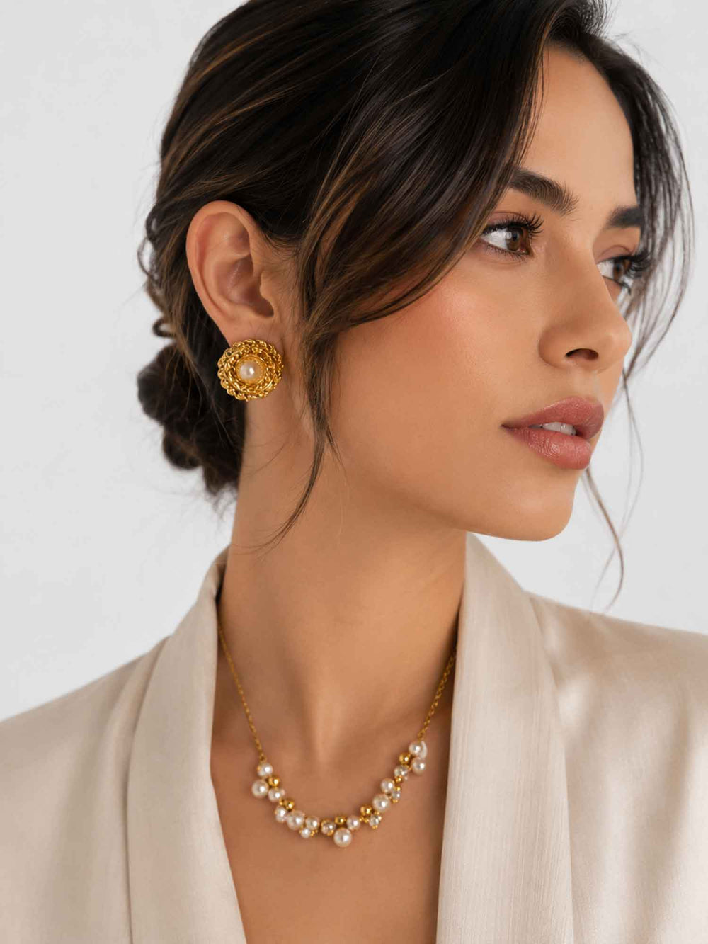 Side view of model wearing vintage-inspired floral pearl gold stud earrings