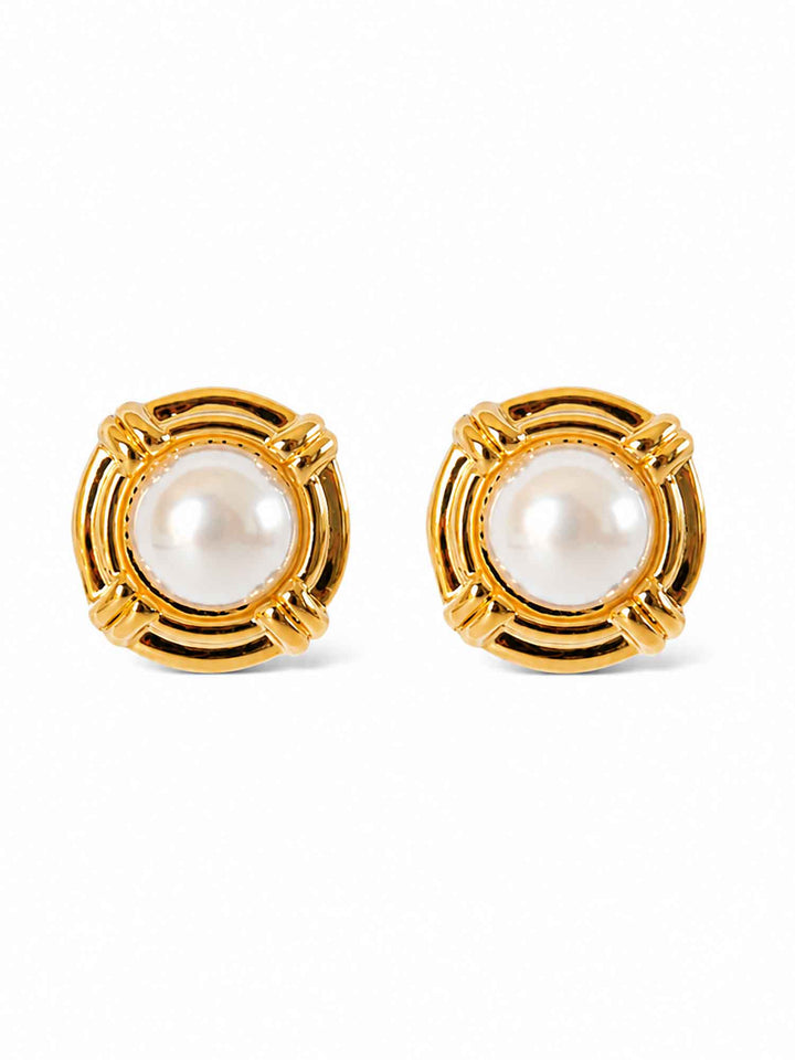 Pair of vintage-inspired gold pearl stud earrings on white background