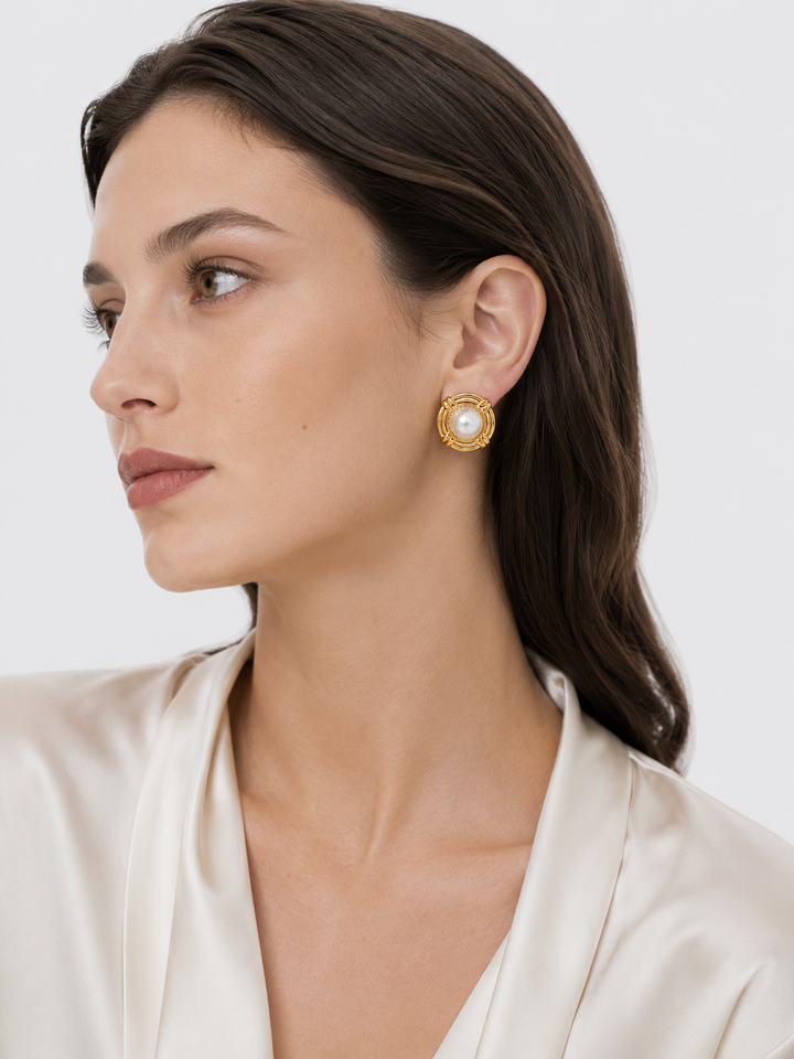 Model wearing vintage-inspired gold pearl stud earrings with elegant everyday styling