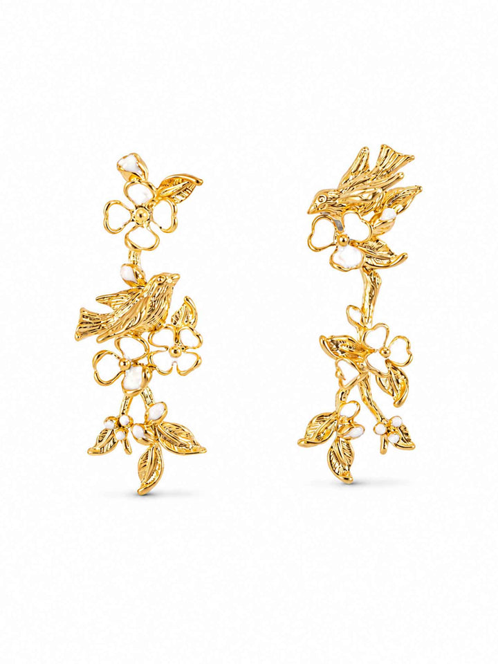 Pair of white floral bird gold drop earrings on white background