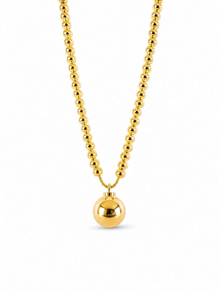 Yara gold ball pendant necklace on white background