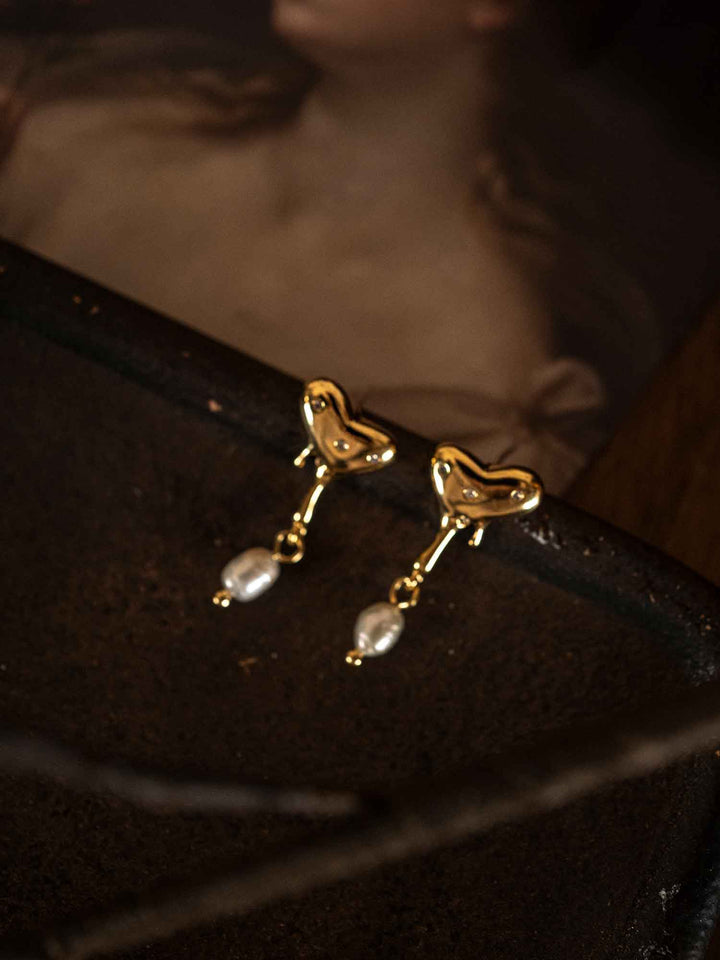Un par de pendientes de perlas en forma de corazón